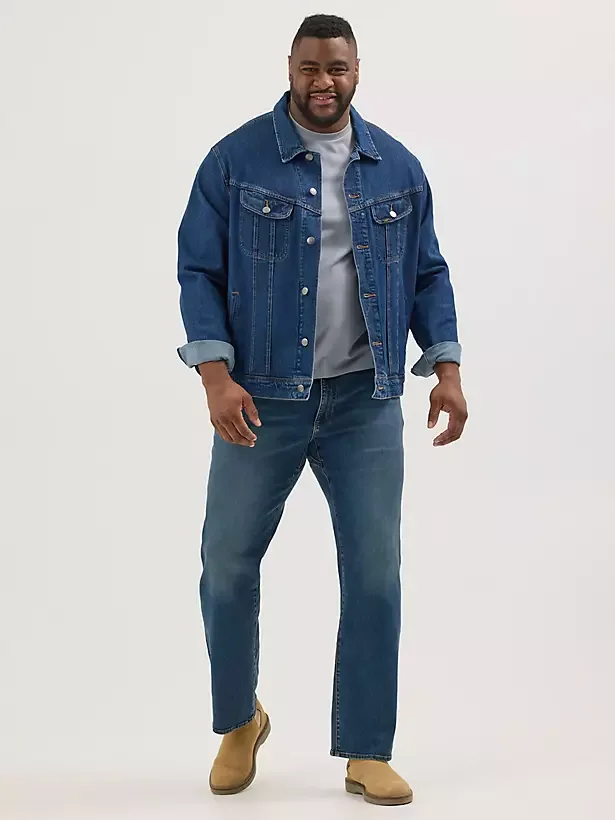 Male model wearing relaxed fit denim jeans.