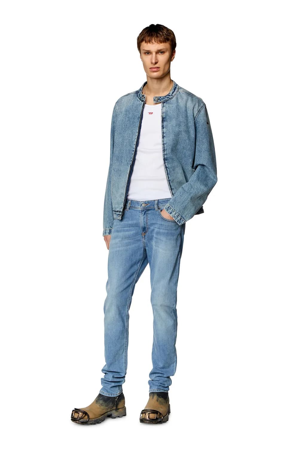 Male model wearing close-fitting skinny denim jeans.