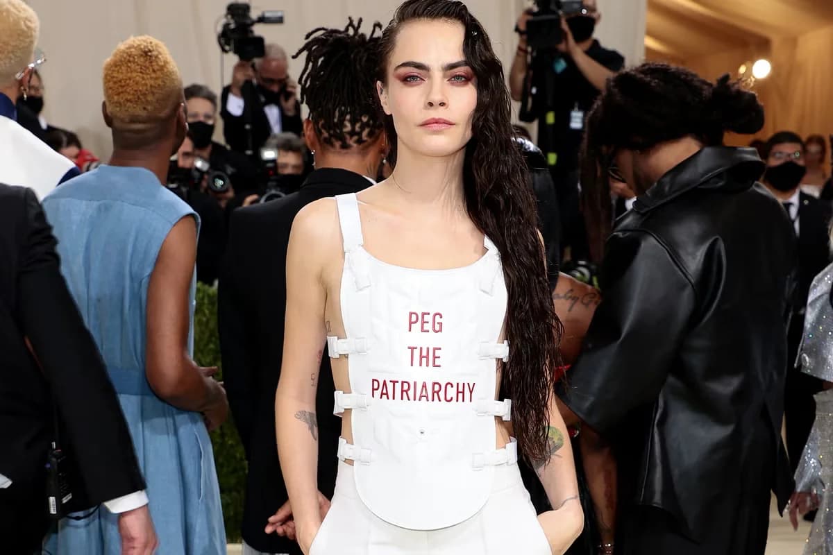 Cara Delevingne wearing a white Dior vest with red lettering at the 2021 Met Gala.