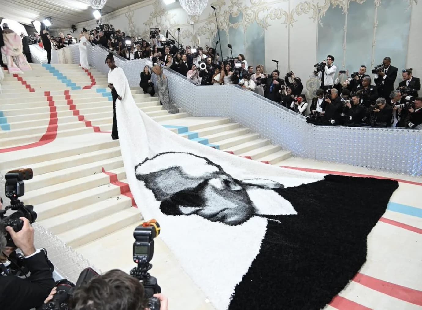 Jeremy Pope wearing a monumental Balmain cape with Karl Lagerfeld profile artwork at the 2023 Met Gala.