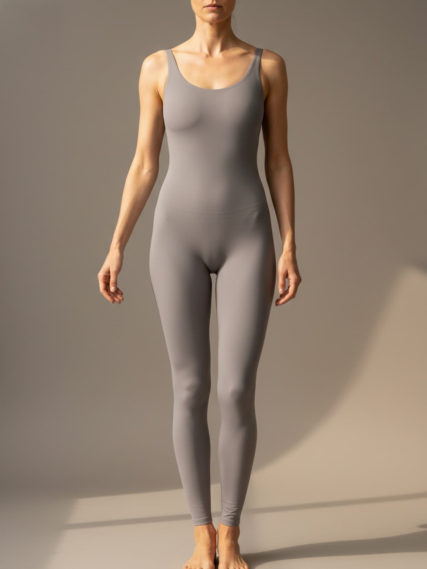 Adult woman with rectangle body proportions in fitted neutral clothing, shown front-facing for anatomical reference.