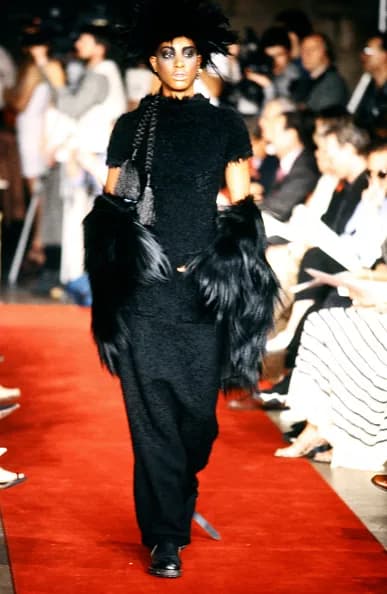 Model on the Jean Paul Gaultier Spring 1997 couture runway in a layered black look.