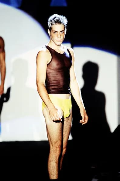 Model on the Gucci Spring 1997 runway wearing a visible logo G-string look.