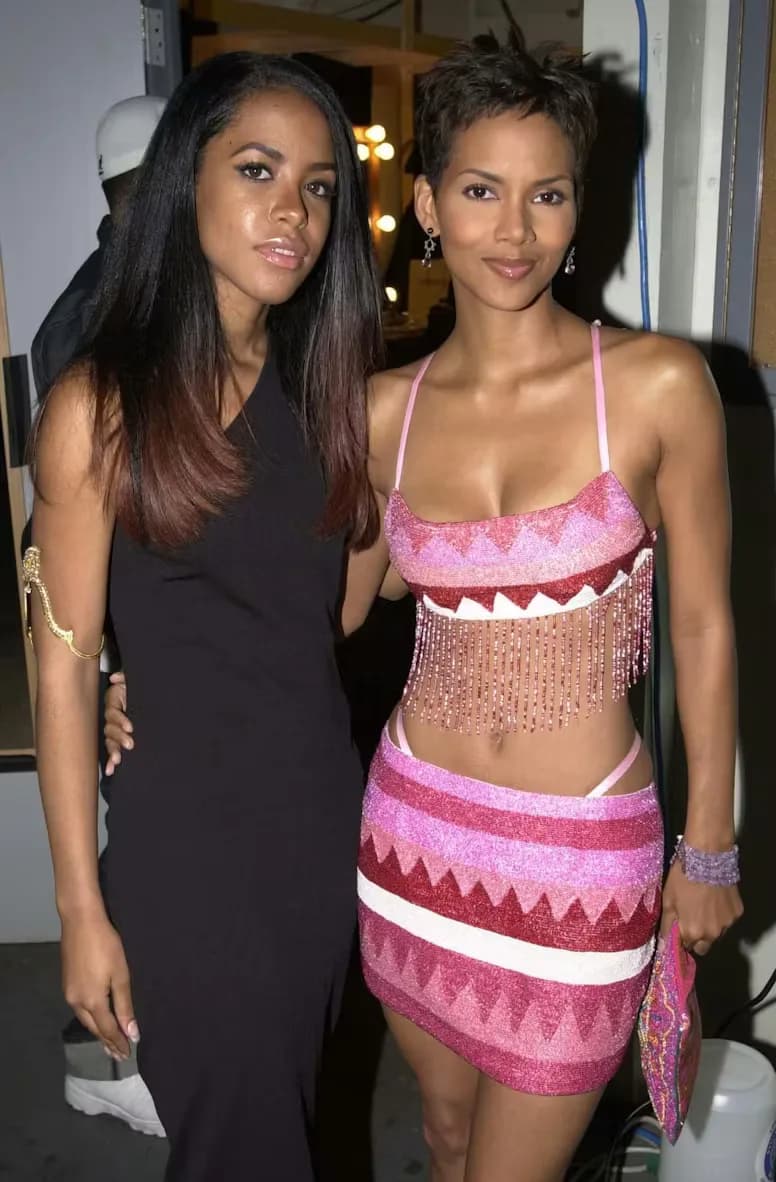 Paris Hilton in a pink early-2000s dress with exposed thong styling.