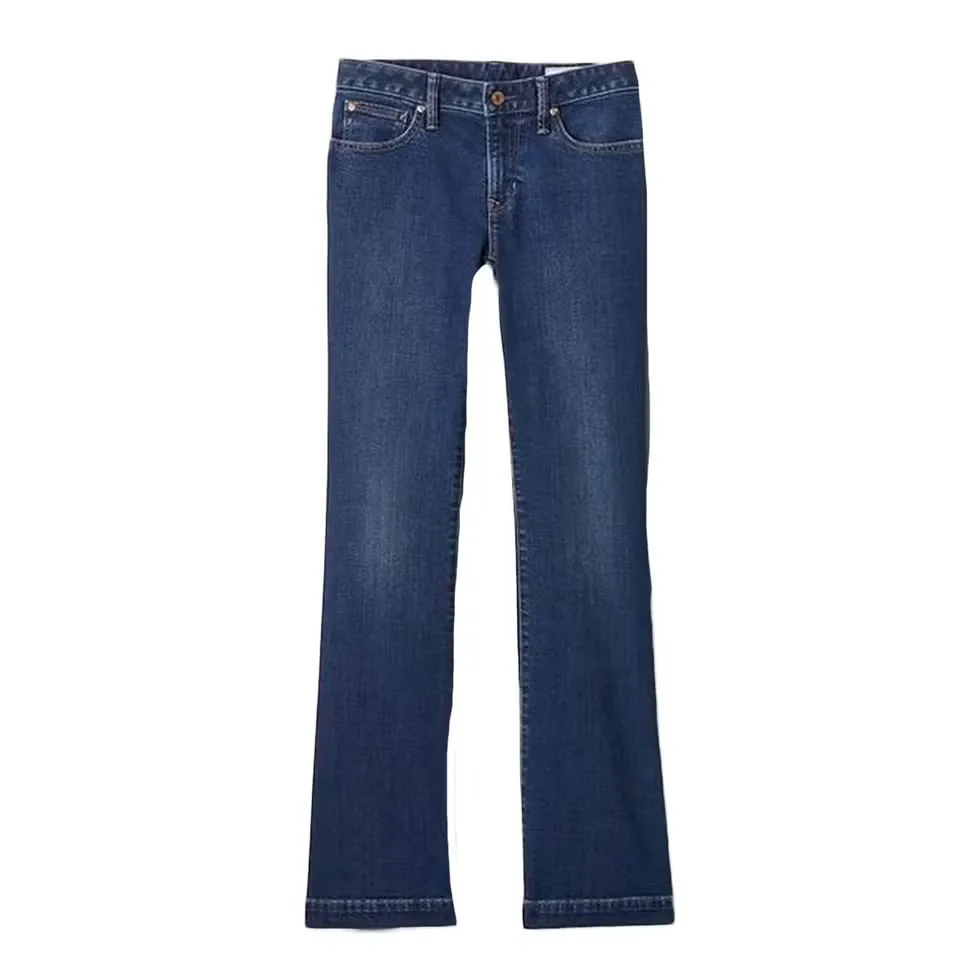 Woman wearing lean bootcut jeans with a subtle flare over footwear.