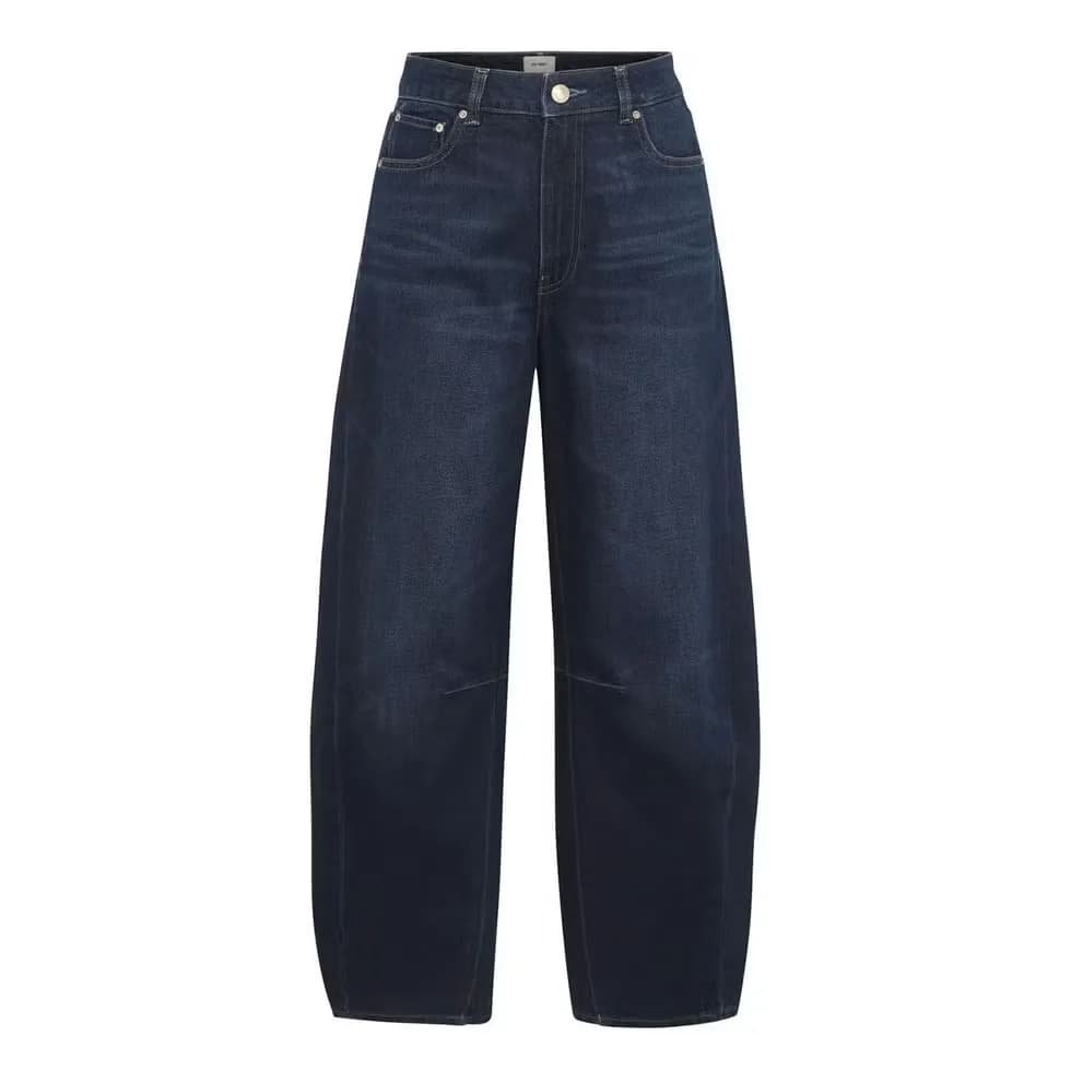 Woman wearing slouchy horseshoe jeans with a curved leg silhouette.