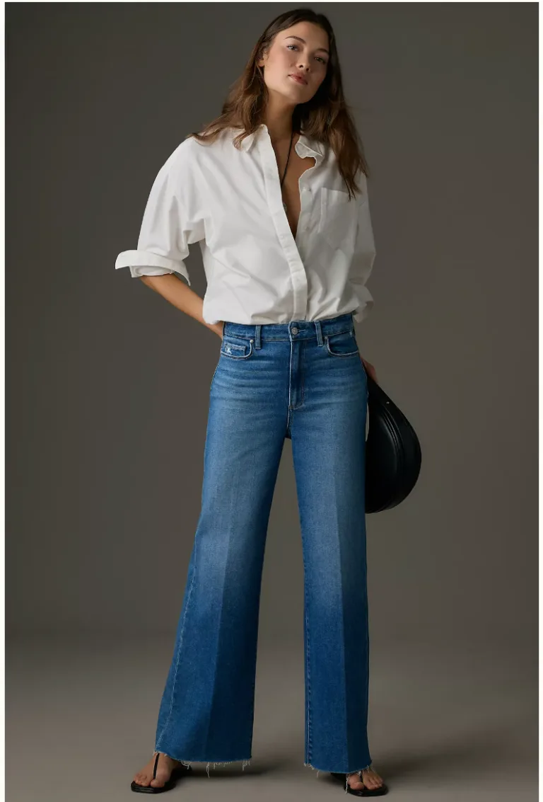 Woman wearing cropped wide-leg jeans with a culotte-like silhouette.