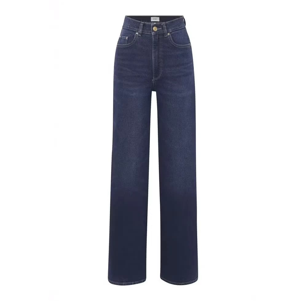 Woman wearing wide-leg denim with a sweeping trouser-like leg.
