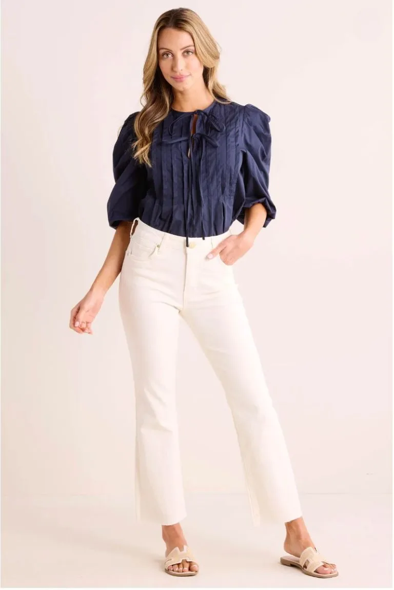 Woman wearing ecru winter white jeans.