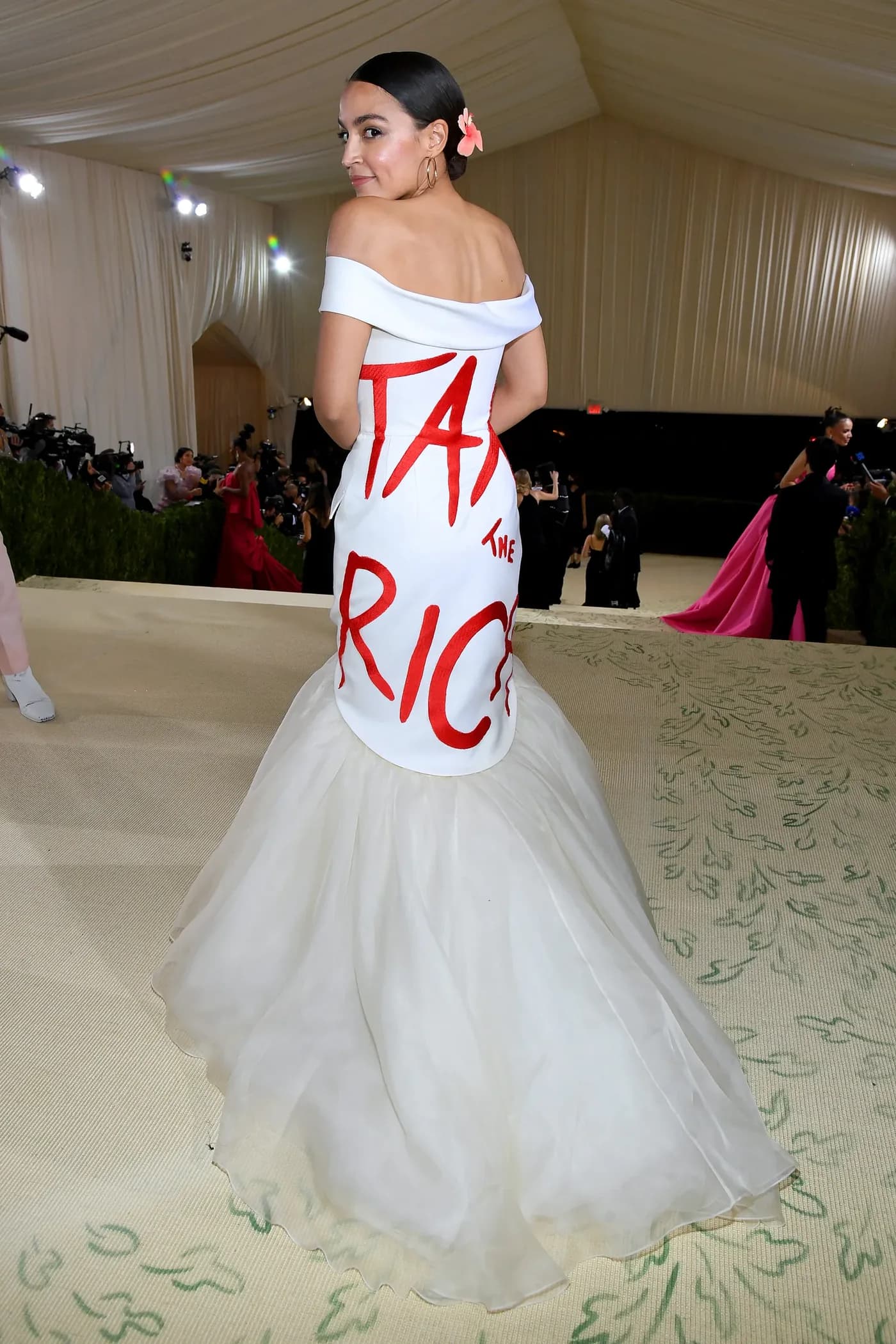 Alexandria Ocasio-Cortez wearing a white Tax the Rich dress by Aurora James at the 2021 Met Gala.